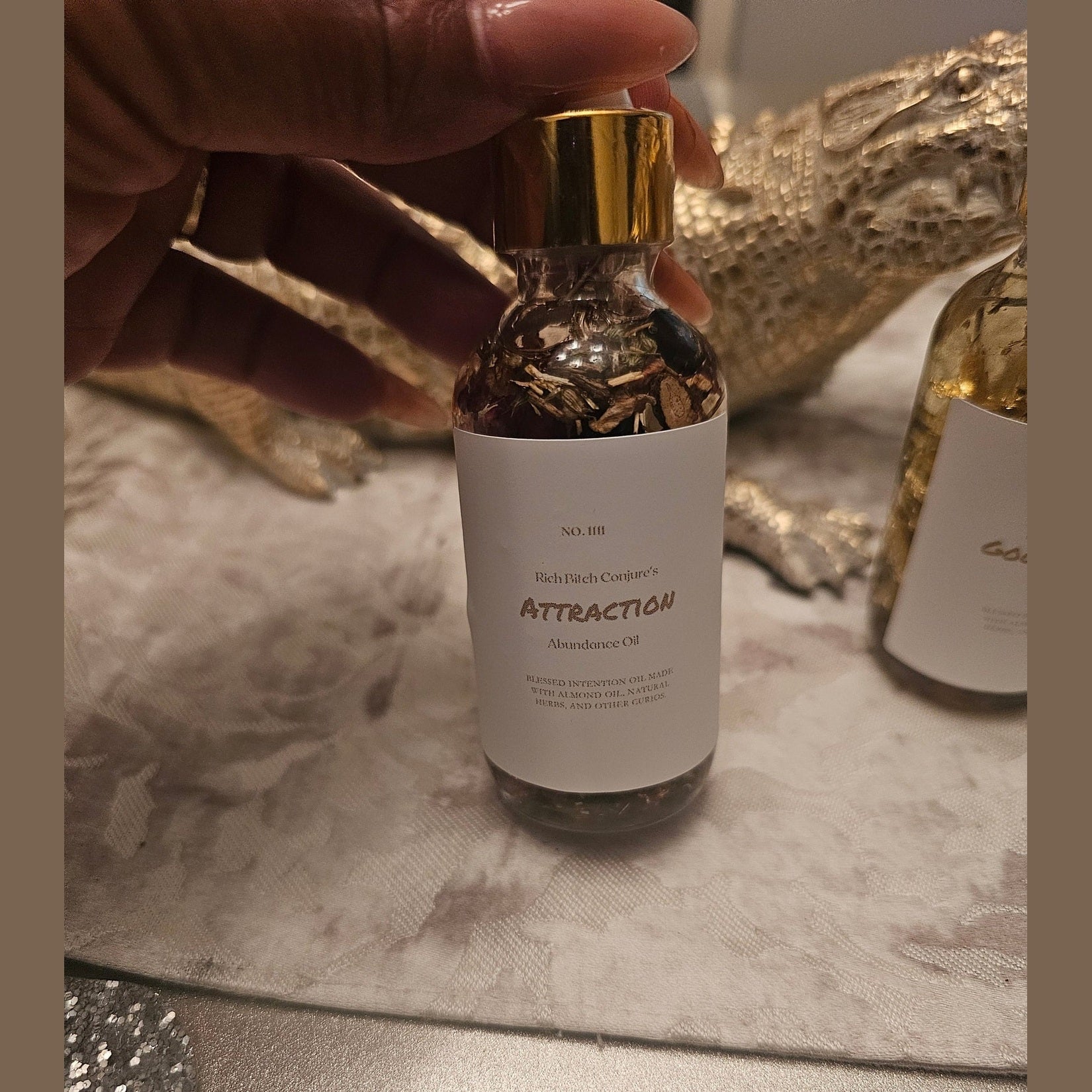 Rich Bitch Conjure Deadly Attraction Hoodoo Oil in a small glass bottle, used for magnetism, love, money, and favor rituals in spiritual rootwork.