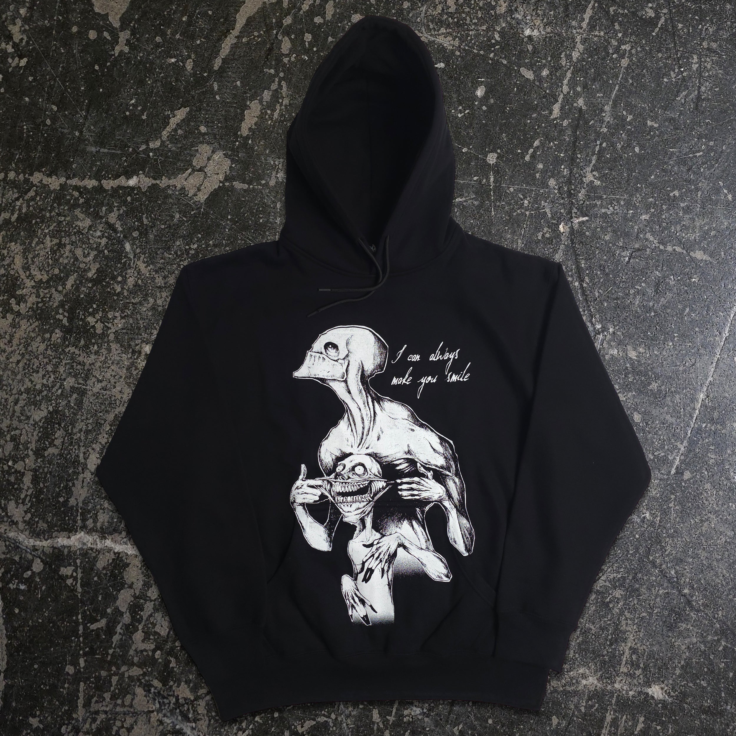 Black Always Smile Pullover Hoodie by Any Means Necessary Clothing, front view showing the smile graphic on the hoodie.