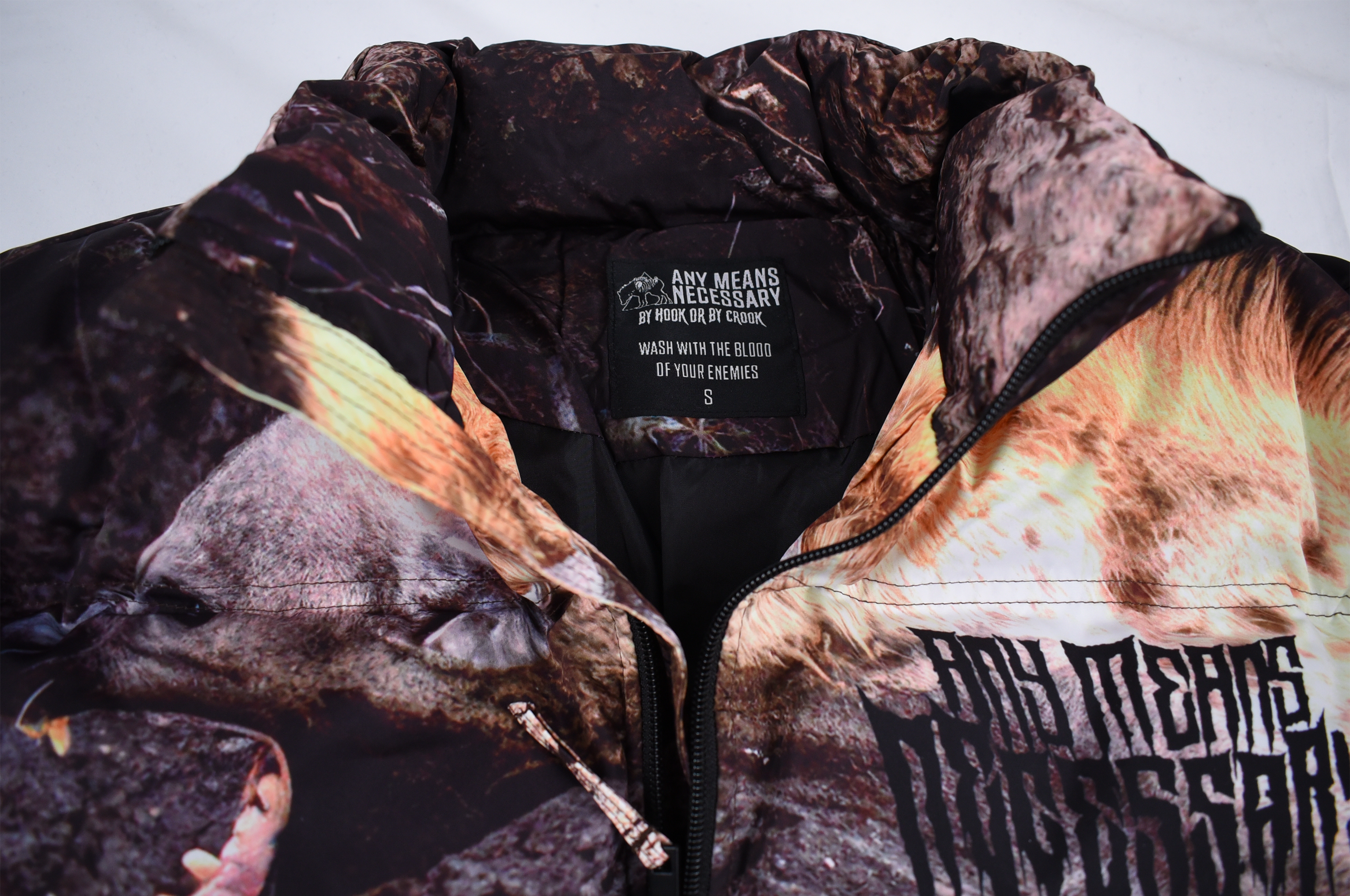 Close-up of Any Means Necessary Clothing Last Stand Puffer Jacket showing quilted design and high collar detail.