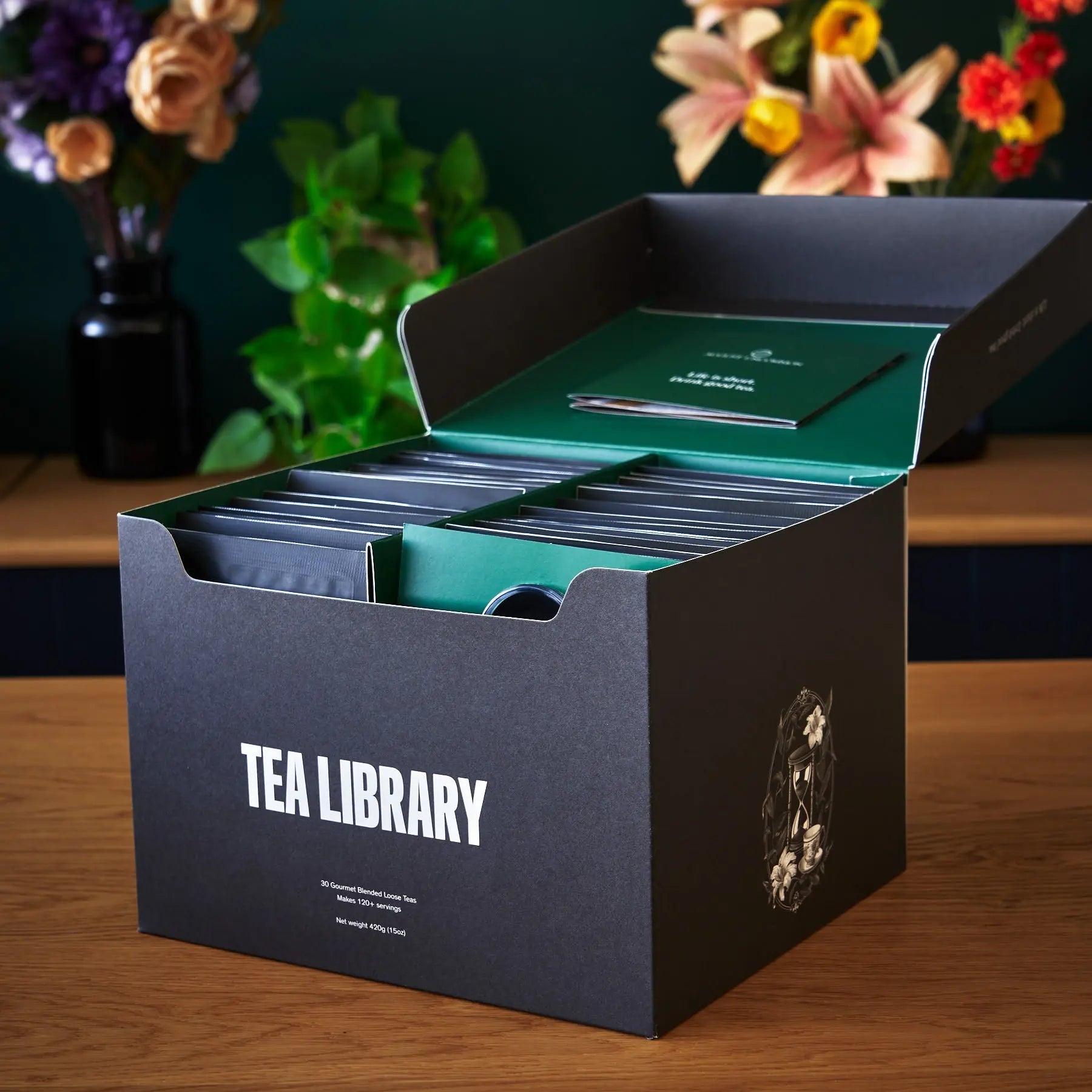 August Uncommon Tea Deluxe 30 Tea Sampler from the Tea Library featuring a variety of fresh loose leaf teas in a display box.