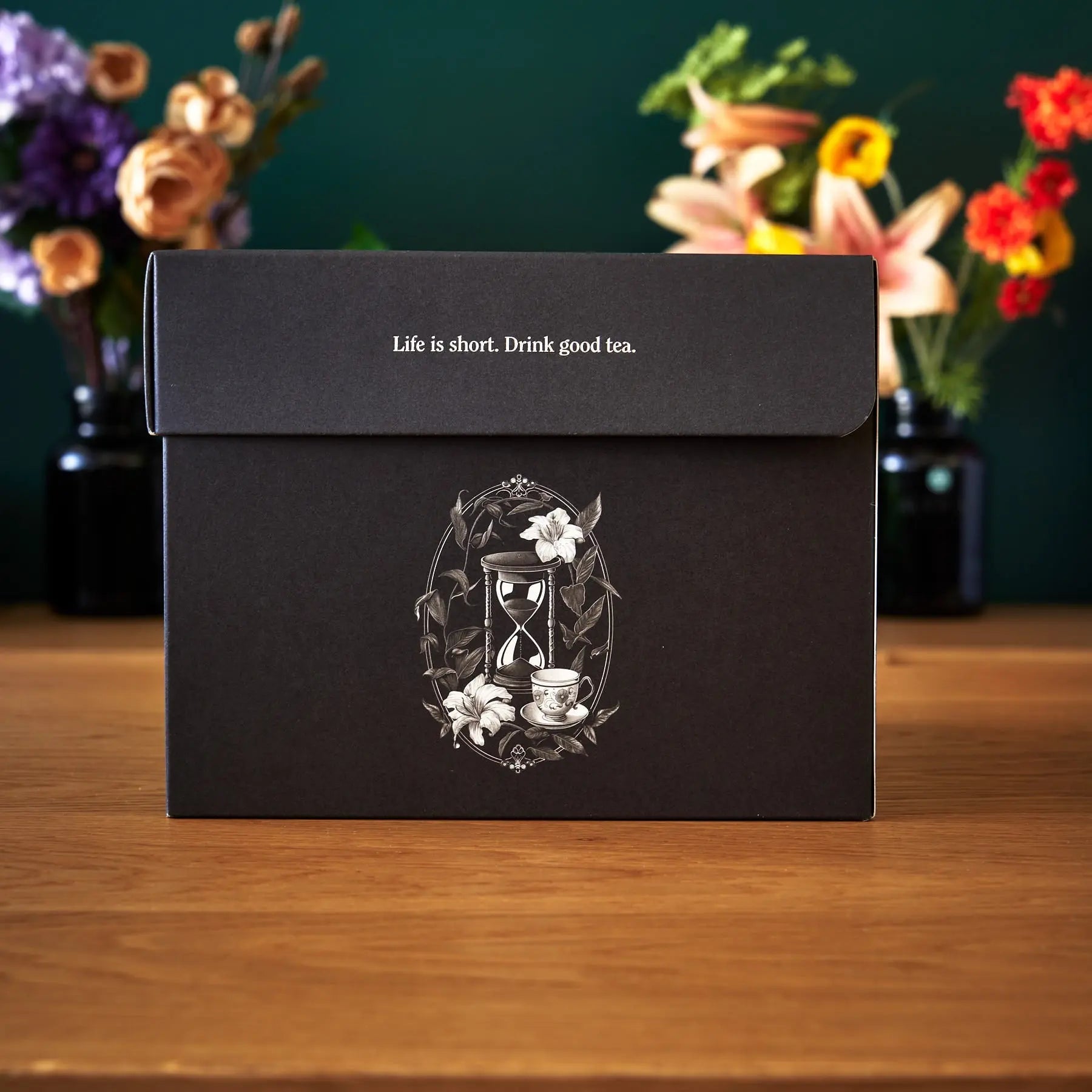 August Uncommon Tea Deluxe 30 Tea Sampler featuring a variety of tea bags in elegant packaging for tasting and brewing.