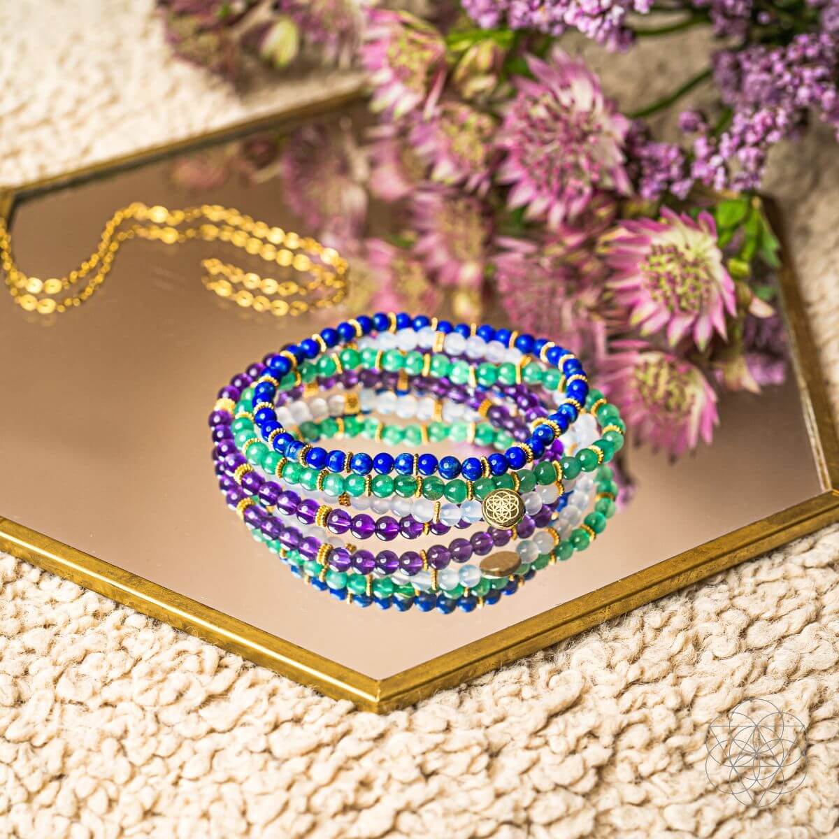 Set of four jewelry bracelets from Conscious Items Good Karma collection, featuring symbols of luck and success.