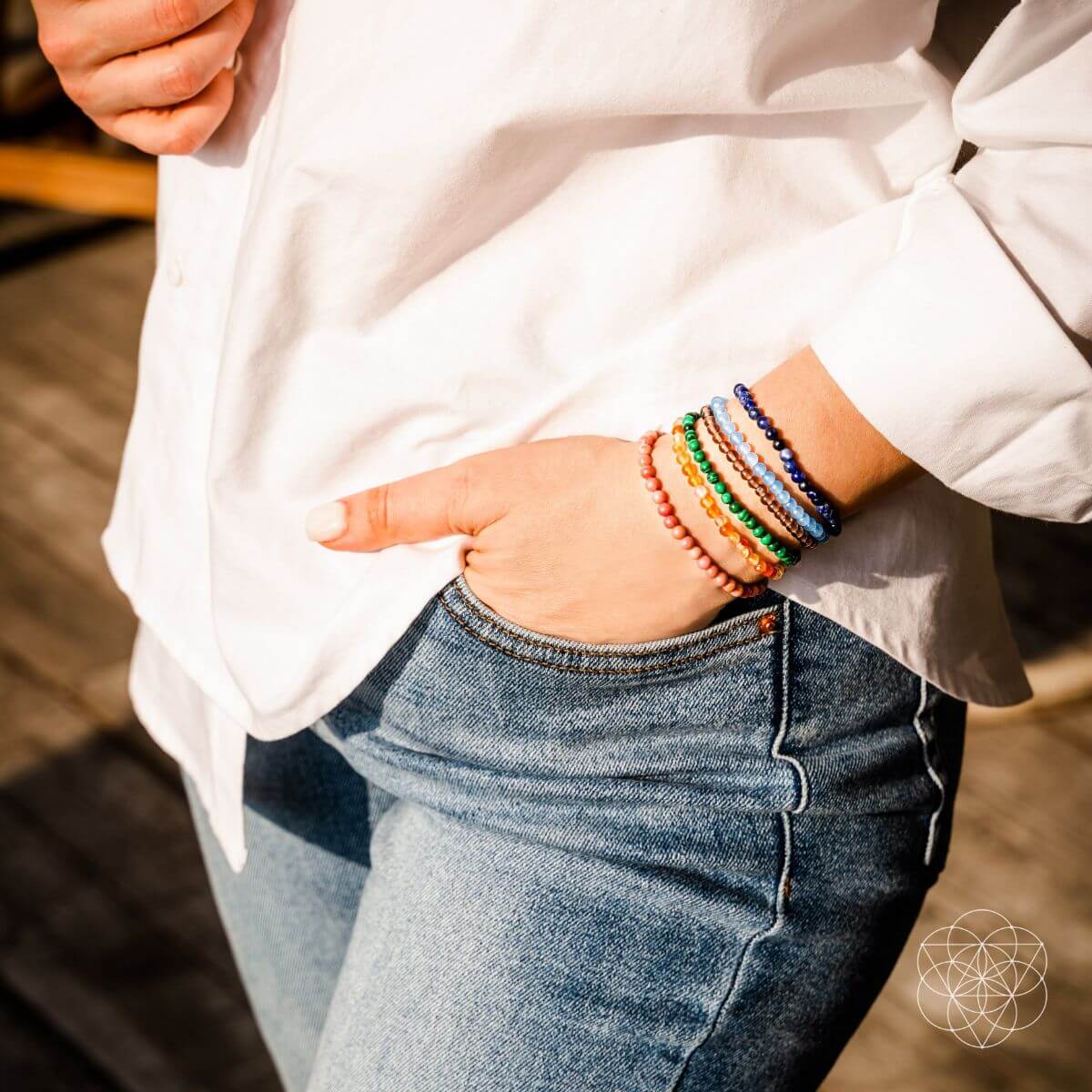Set of chakra-balancing jewelry bracelets by Conscious Items featuring colorful beads and charms for spiritual wellness.