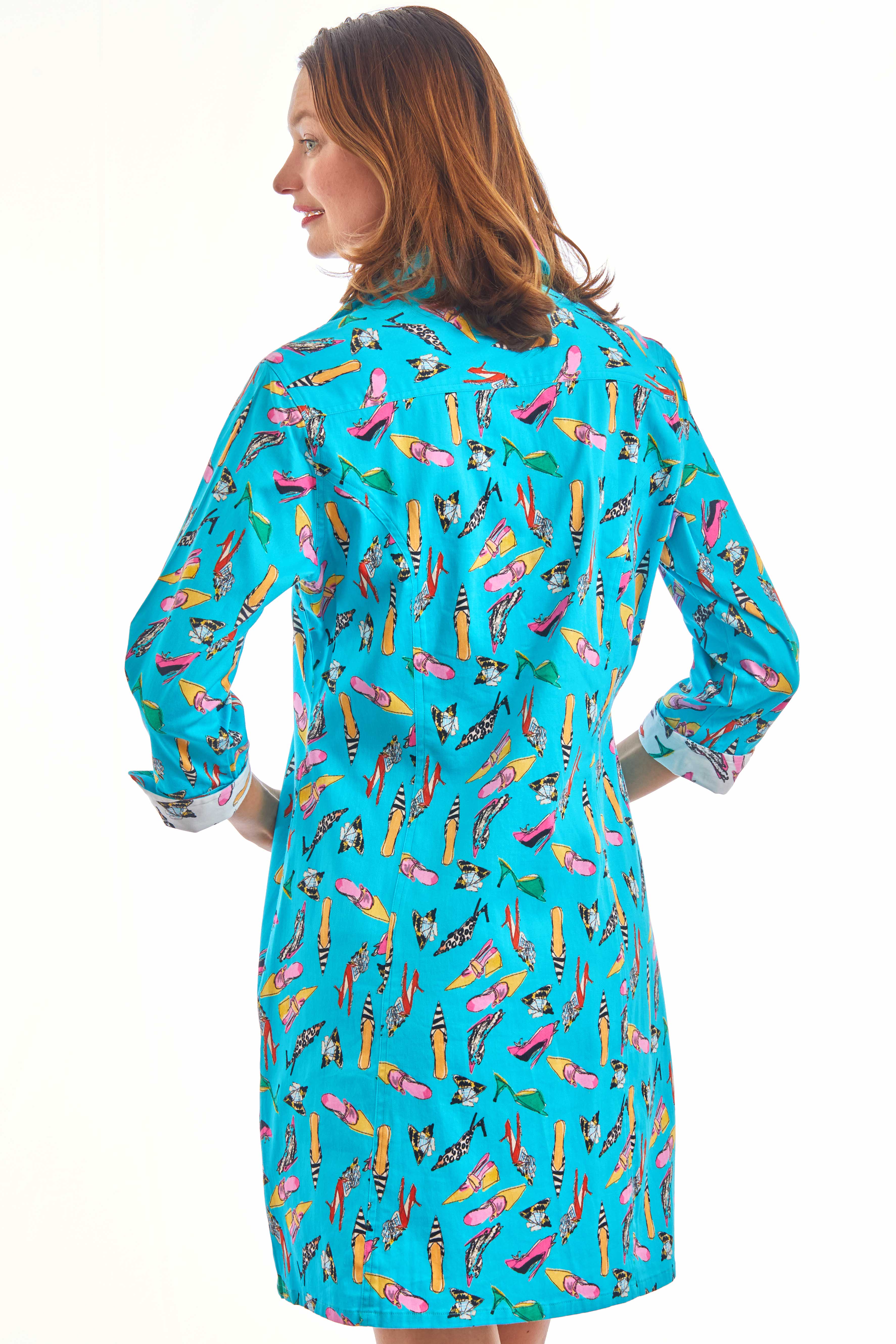 Turquoise Sag Harbor Dress by Dizzy-Lizzie featuring a playful shoe print design, displayed on a hanger.