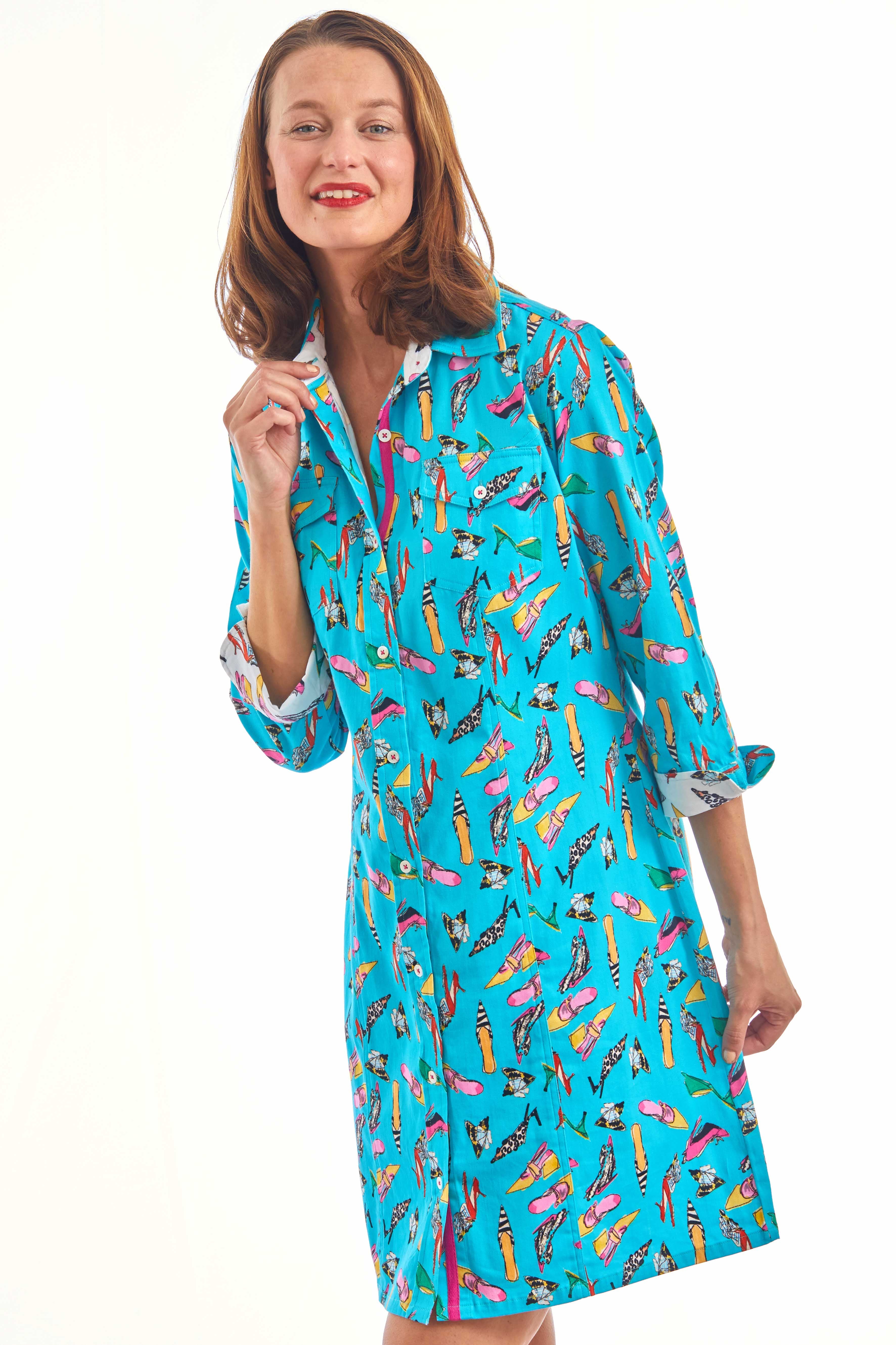 Turquoise Sag Harbor Dress by Dizzy-Lizzie featuring a shoe print pattern, displayed on a hanger against a neutral background.