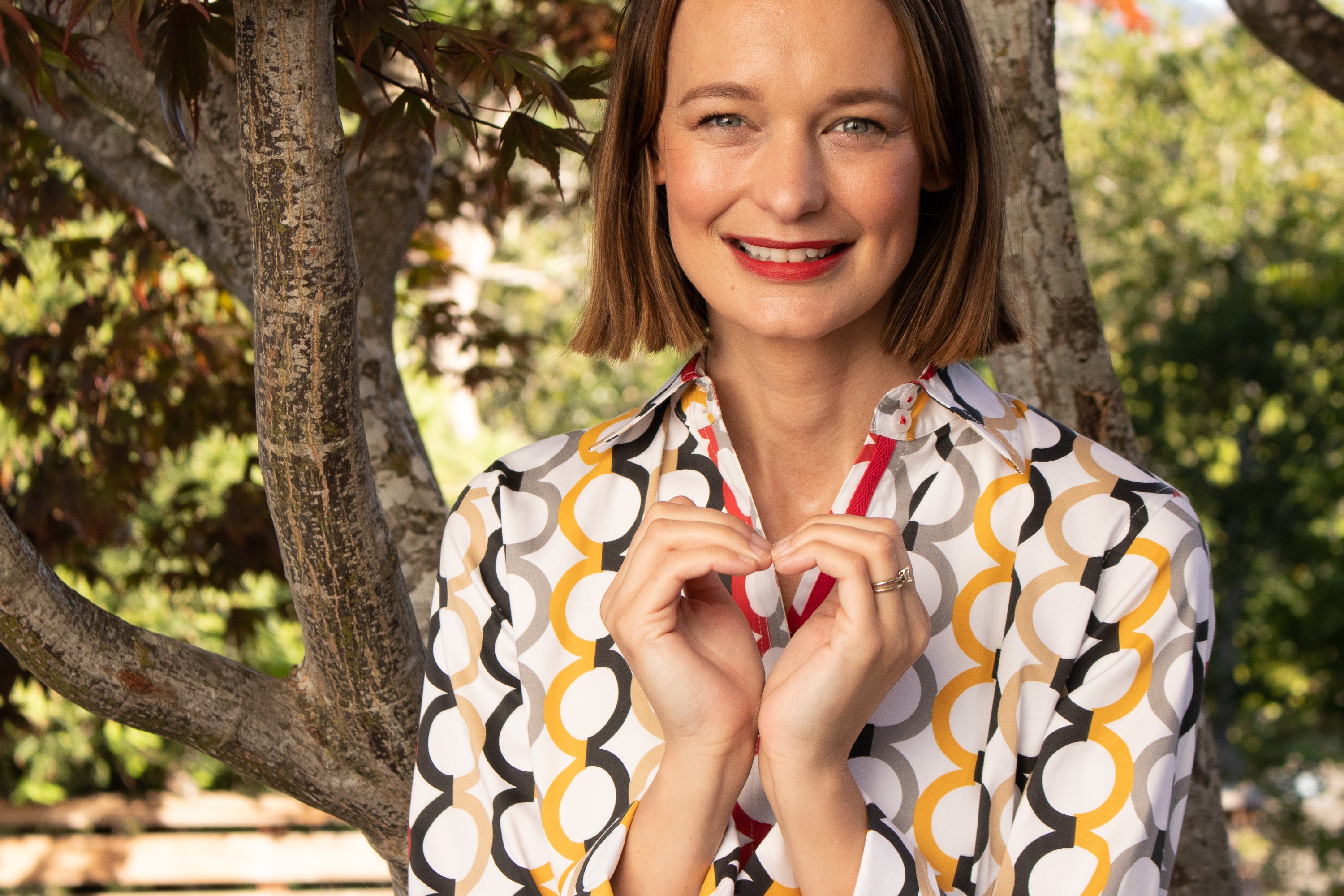 Dizzy-Lizzie Rome Shirt in fall colors featuring Olympic ring print, casual shirt with vibrant autumn-inspired design.