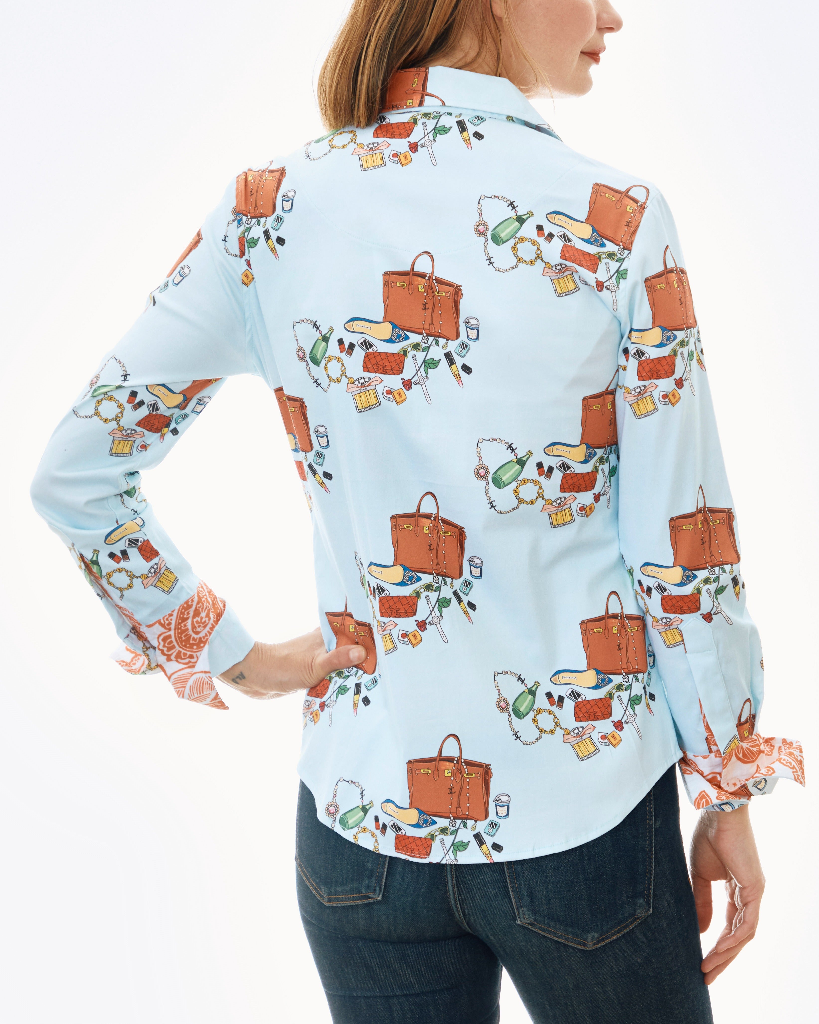 Dizzy-Lizzie Rome shirt paired with Perrier and Kelly bags, featuring stylish design and vibrant colors in a casual outfit.