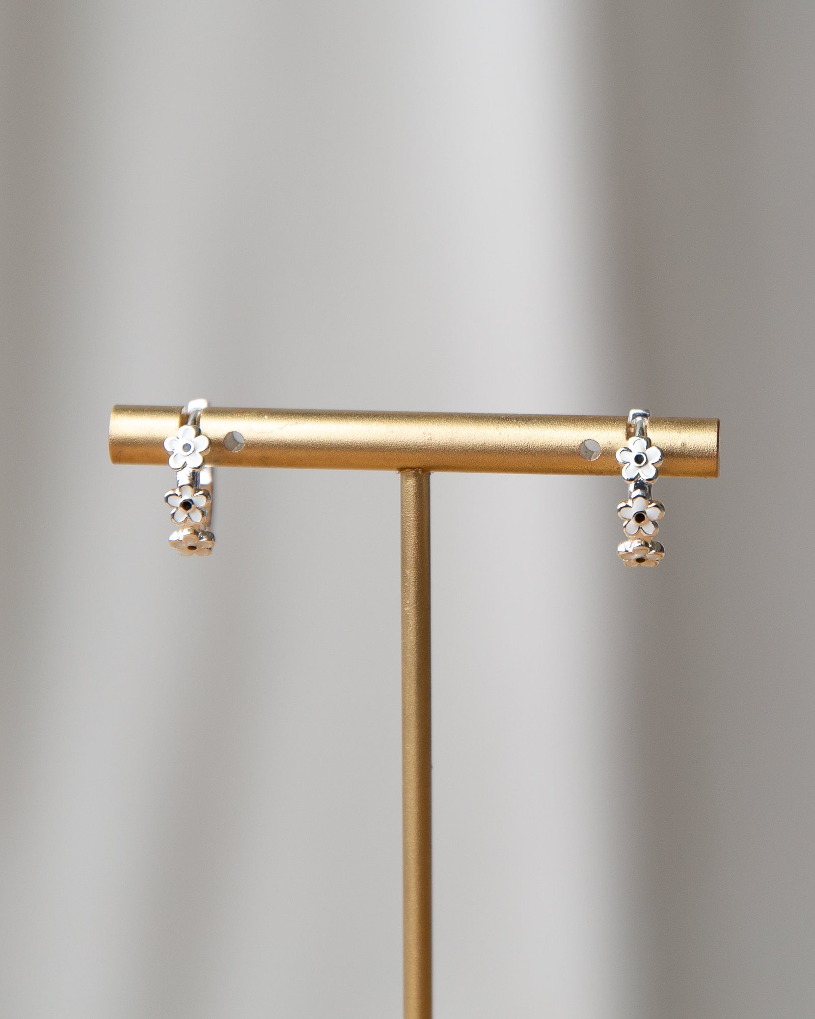 Silver In Bloom Huggie Hoop earrings by Downeast, featuring delicate floral design and a polished silver finish.