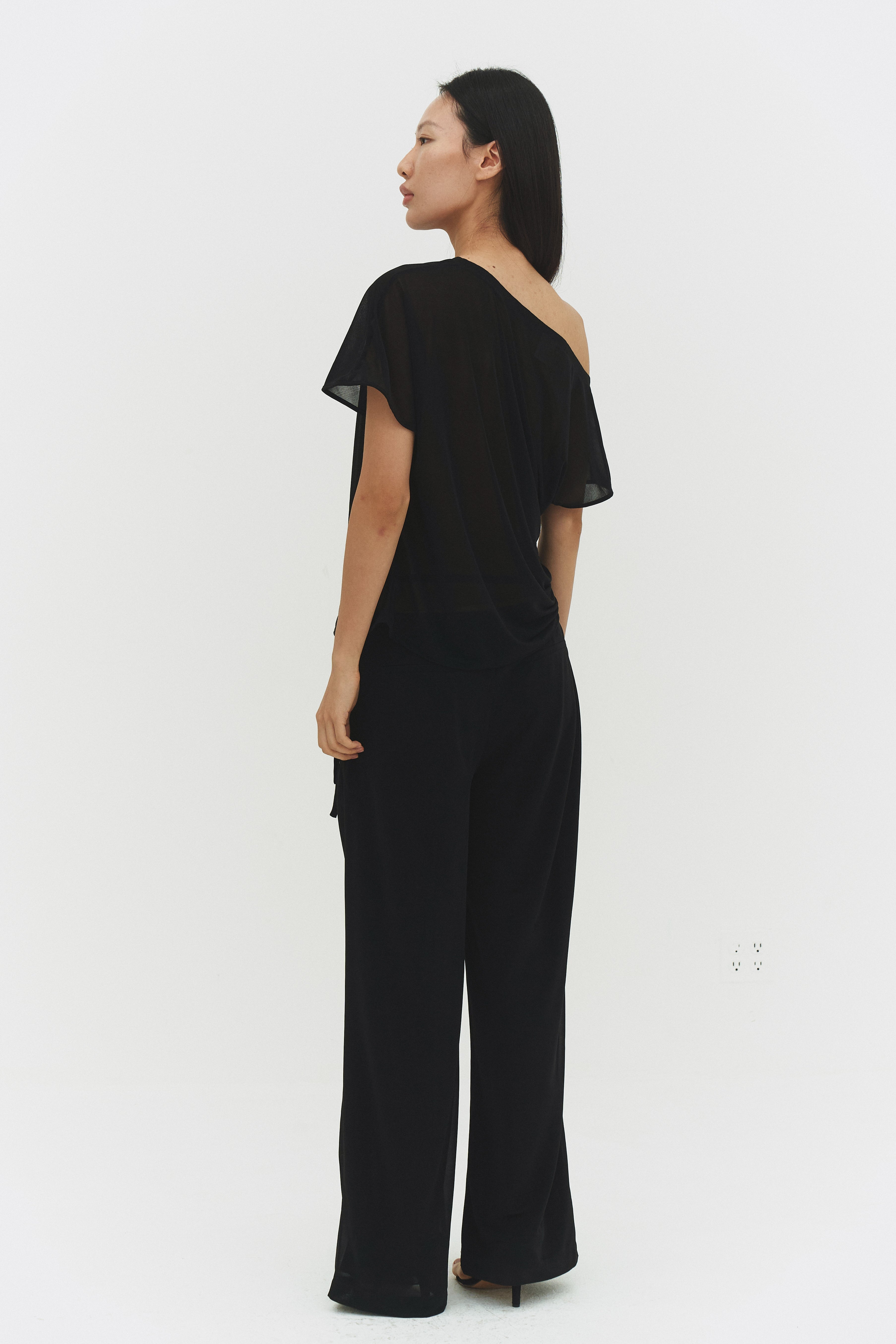Black BRISA top by findmenowthelabel featuring a fitted design and soft fabric, shown on a model in a casual setting.