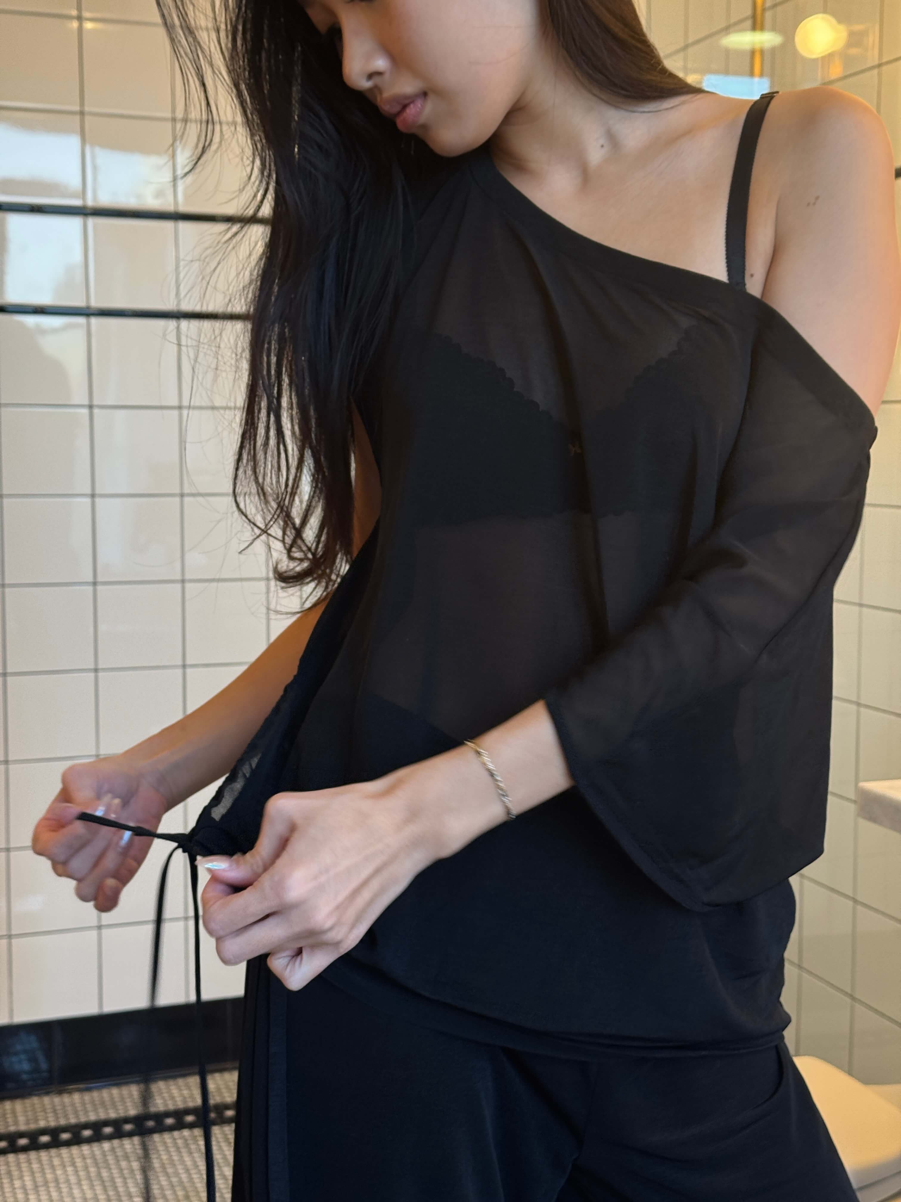 Black Brisa top by findmenowthelabel, featuring a fitted silhouette and soft fabric, shown on a model.