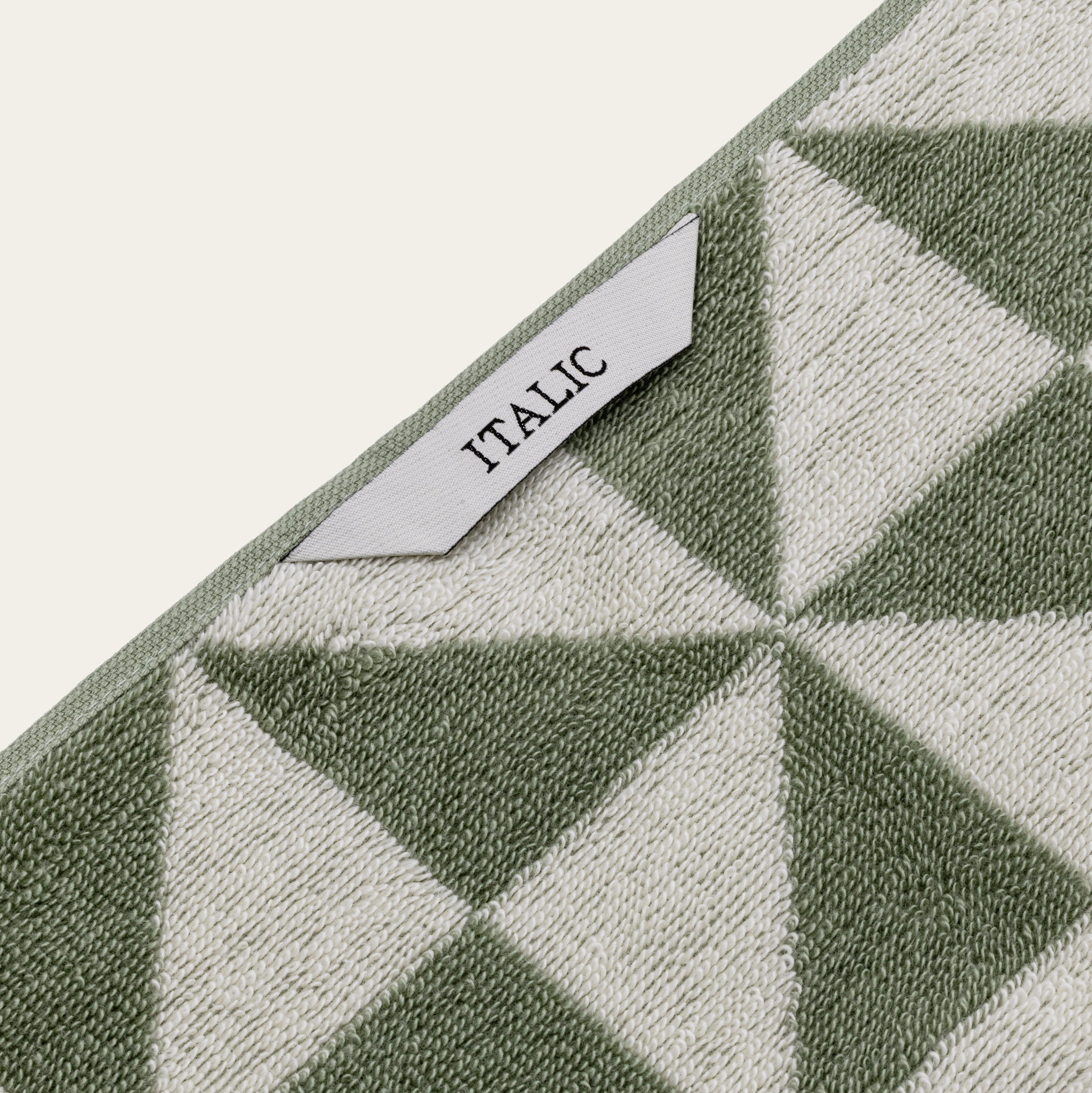Italic Umbra Australian Cotton Bath Towel set with soft, plush white towels hanging on a bathroom rack.