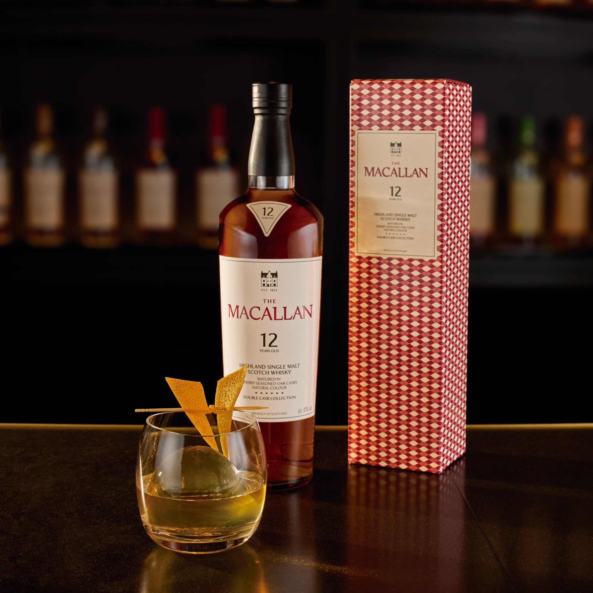 A 750ml bottle of The Macallan 12 Year Old Double Cask Single Malt Scotch Whiskey, with a dark brown label and elegant packaging.