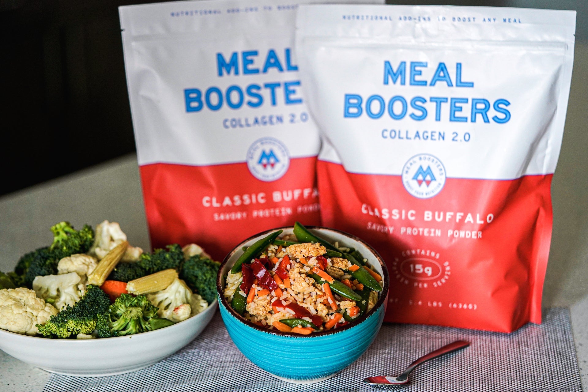Classic Buffalo collagen and protein blend powder from Meal Boosters, shown with a stir-fry dish.