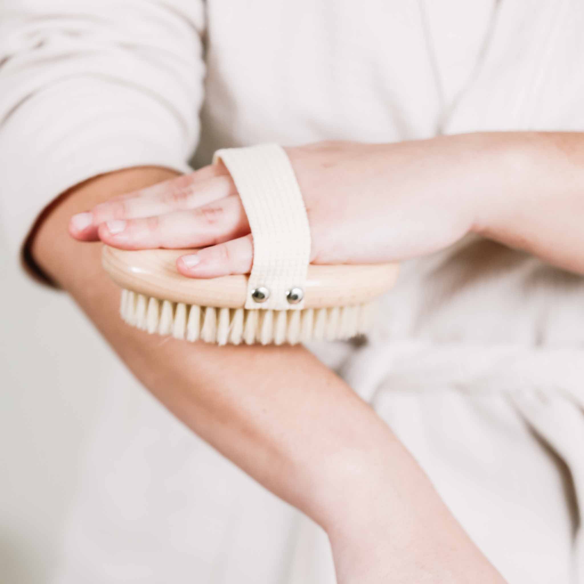Pretty farm girl dry body brush made of natural bristles with a wooden handle, designed for exfoliating and skin rejuvenation.