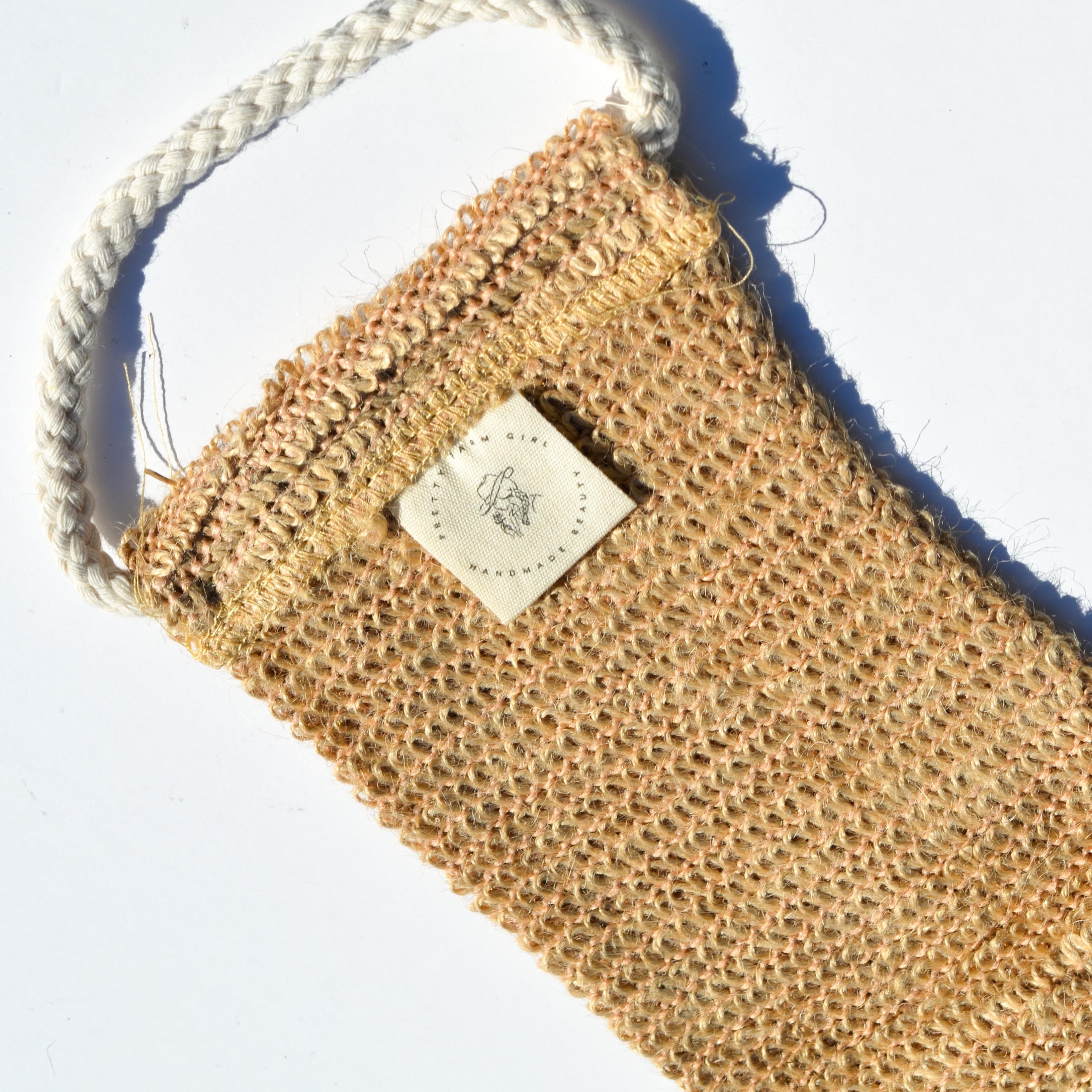 Sisal back exfoliating strap by Pretty Farm Girl, natural textured accessory for skin exfoliation and cleansing.