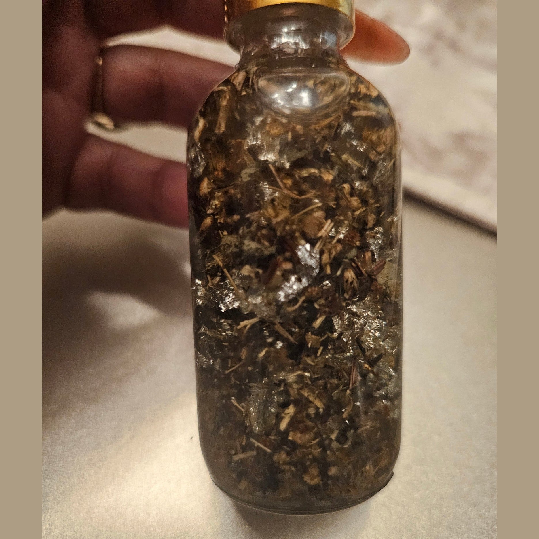 Rich Bitch Conjure hoodoo oil labeled Rich Witch Bitch Intuitive Oil, featuring a dark glass bottle with a black and gold label.
