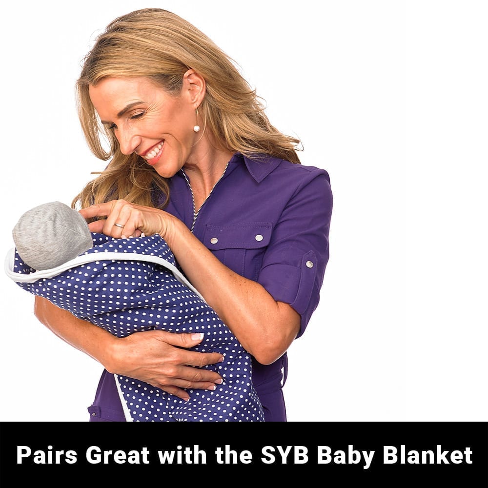 Shield Your Body SYB Baby Beanie paired with a soft blue blanket, cozy and warm for infants and toddlers.