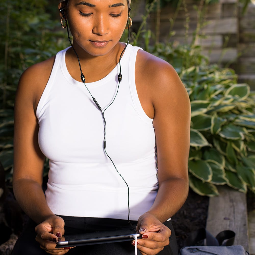 Shield Your Body SYB Tablet Pad supporting a woman outdoors, used as a stand for tablet computer in a natural setting.