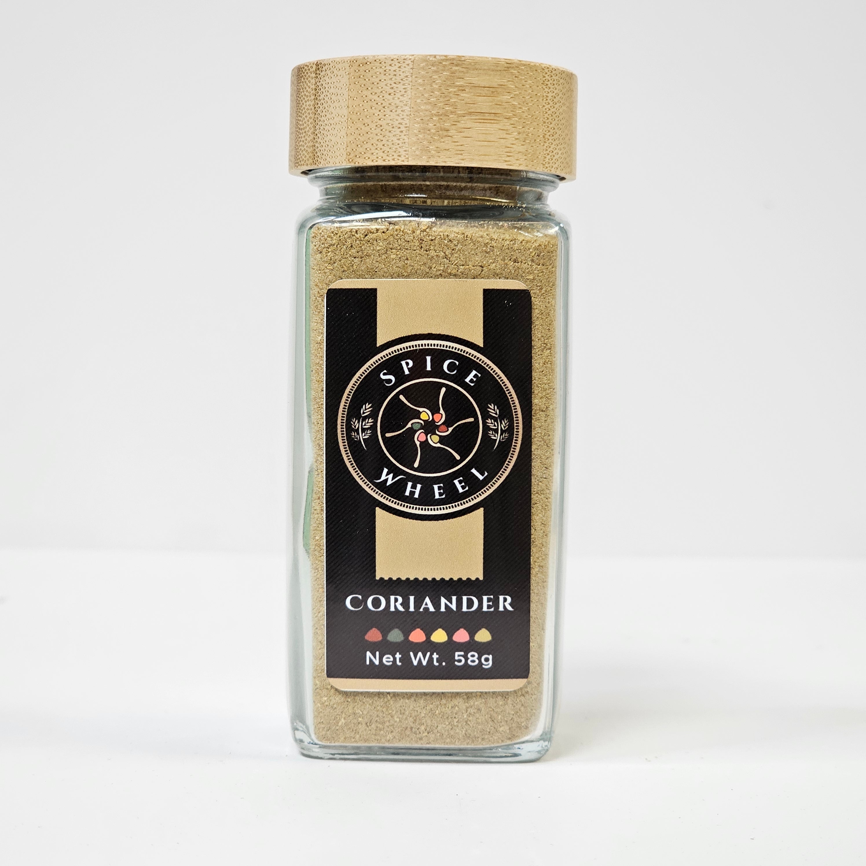 Glass jar of Spice Wheel coriander powder, showing the finely ground green herb inside the clear container.