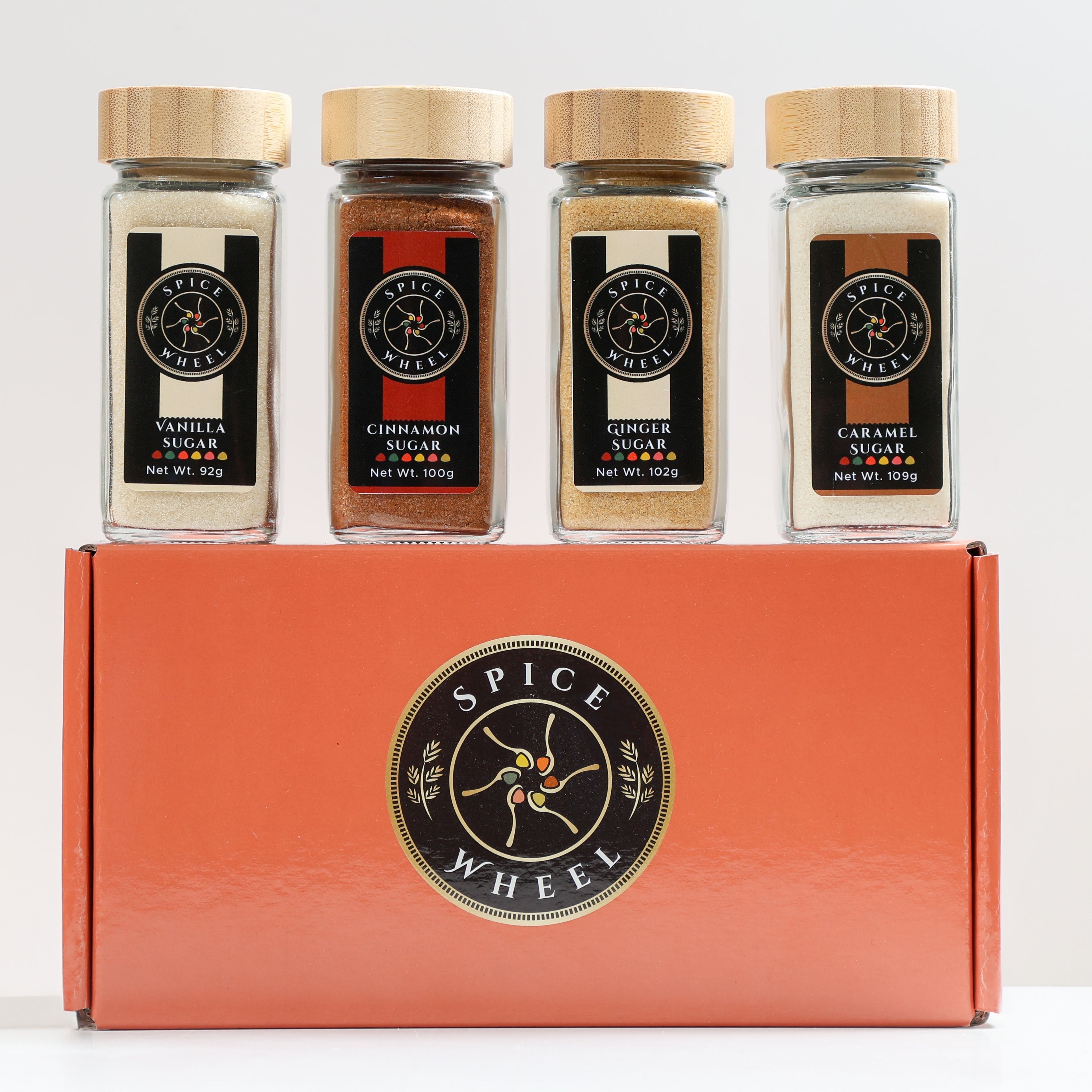 Spice Wheel Cozy Sugar Gift Set with vanilla, cinnamon, ginger, and caramel spices in a colorful 4-pack.