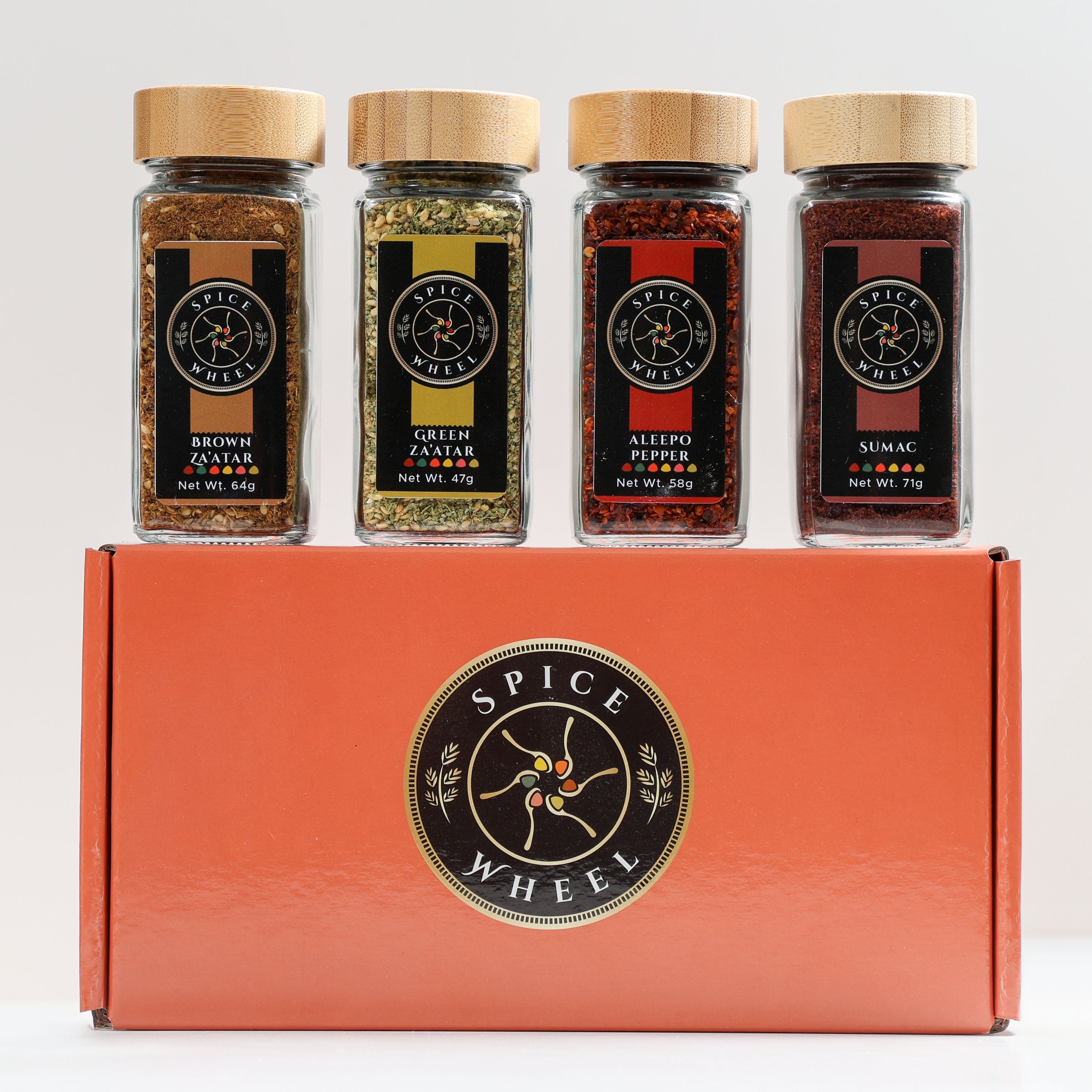 Mediterranean Spice Essentials Gift Set with four Spice Wheel spice jars, featuring colorful labeled glass containers.
