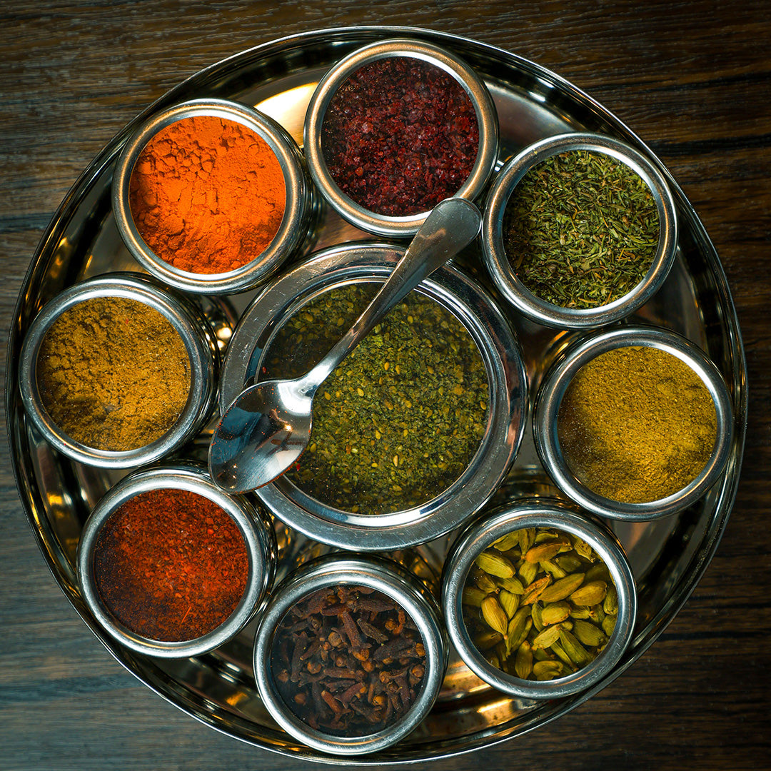 Mediterranean Spice Wheel by Spice Wheel showing colorful sections of various Mediterranean spices on a square background.