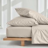 Soft white Luxe Australian Sateen Sheet Set by Italic on a bed with neatly made sheets and pillows, showcasing luxurious bedding.