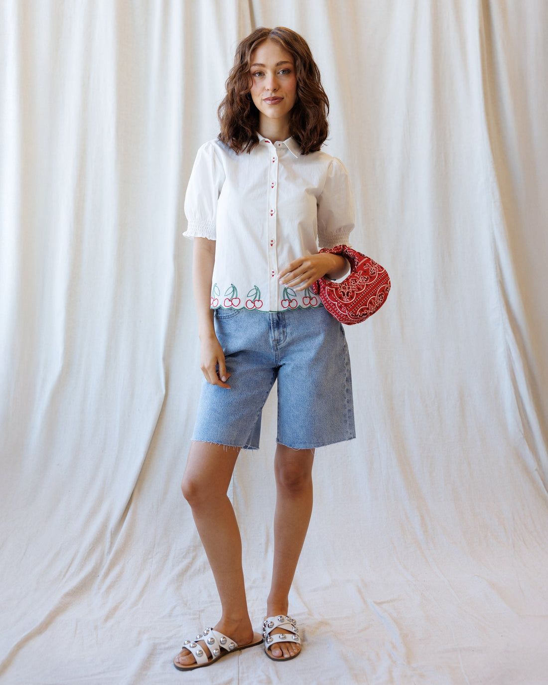 Cherry Cute Button Down top by Downeast, featuring a vibrant cherry print, long sleeves, and a classic collar.