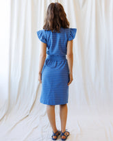 Downeast On Repeat Dress in a flowy, patterned fabric with long sleeves and a relaxed fit, displayed on a hanger.