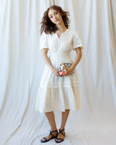 Downeast Icon Demi Lace Dress displayed on hanger with intricate lace details and elegant design.