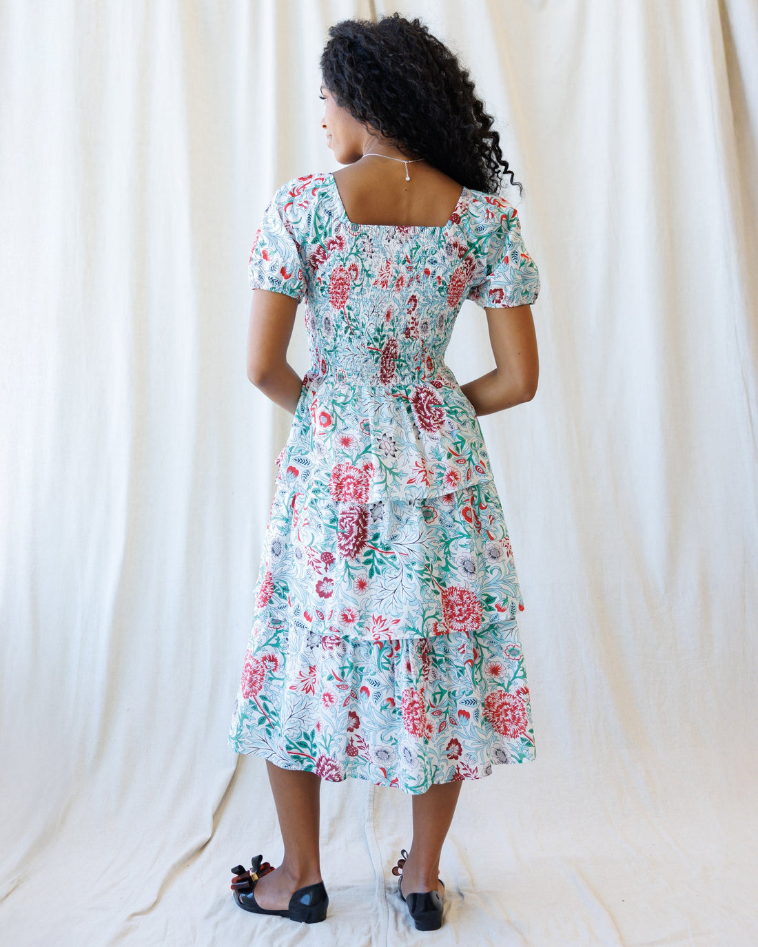 Downeast complimentary colors dress displayed on a hanger, featuring vibrant fabric and a stylish, casual design.