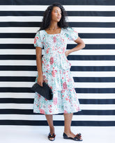 Downeast complimentary colors dress displayed on a hanger, featuring a vibrant, multicolored design and lightweight fabric.