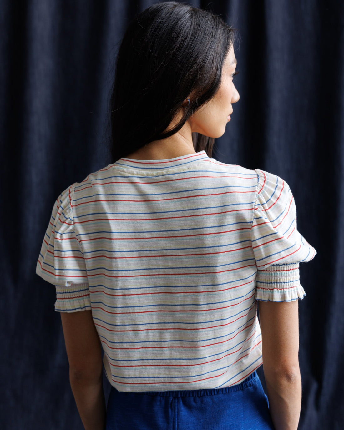 Downeast Tres Belle Top shown on a hanger, featuring a stylish, casual blouse with a soft fabric and elegant neckline.