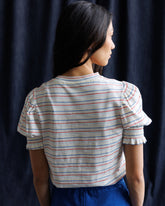 Downeast Tres Belle Top shown on a hanger, featuring a stylish, casual blouse with a soft fabric and elegant neckline.