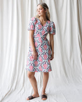 Downeast Capri dress hanging on a hanger, lightweight and casual summer dress with a floral pattern and sleeveless design.