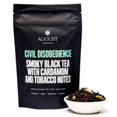 Civil Disobedience smoky cardamom black tea in a black tea bag from August Uncommon Tea, with a rich, aromatic appearance.