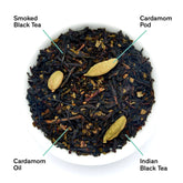 Dried smoky cardamom black tea leaves from August Uncommon Tea, shown in a close-up image with detailed leaf texture.