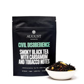 Four cups of Civil Disobedience Smoky Cardamom Black Tea by August Uncommon Tea, showcasing the rich, dark brewed tea in a cozy setting.