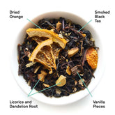 Close-up of Mood Indigo smoky orange vanilla black tea leaves from August Uncommon Tea, showing dark and aromatic tea leaves.