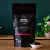 Smoky orange vanilla black tea from August Uncommon Tea in a 70-cup bag, showcasing rich tea leaves and vibrant packaging.
