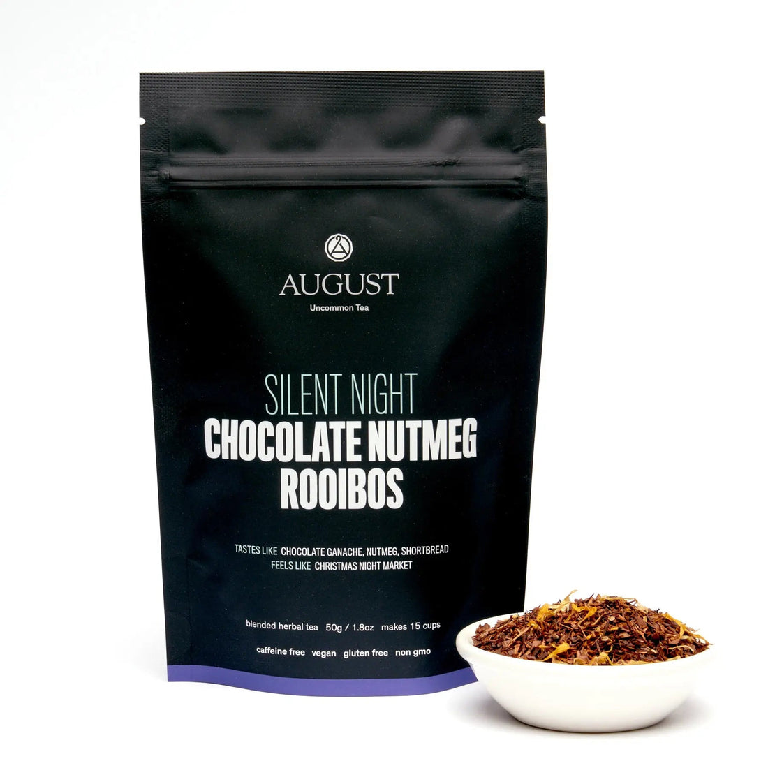 Cup of Silent Night herbal tea with chocolate and nutmeg aroma from August Uncommon Tea, caffeine-free rooibos blend in a 15-cup bag.