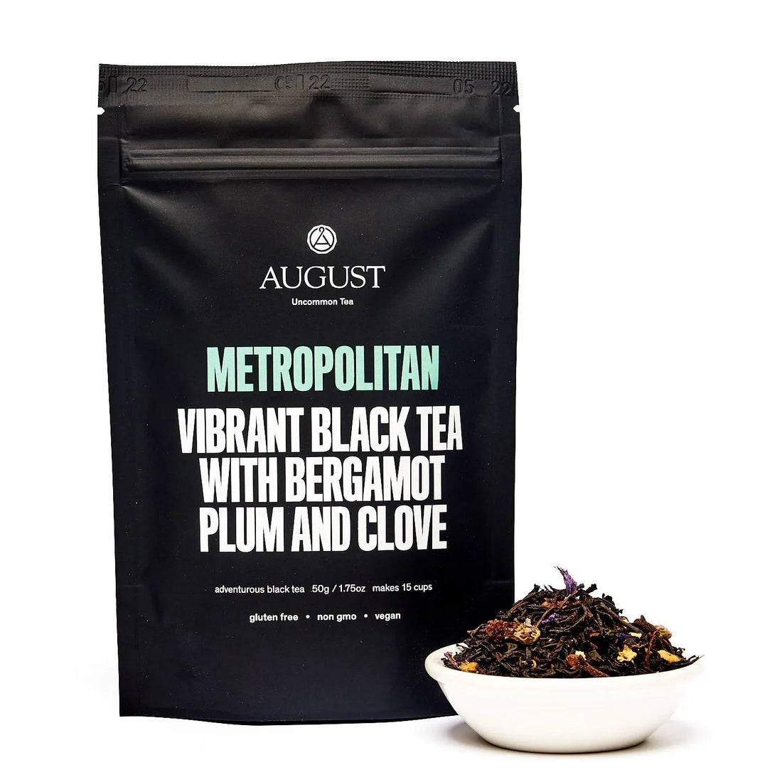 Box of August Uncommon Tea Metropolitan Bergamot Plum Earl Grey black tea in a 15-cup bag, featuring elegant packaging and fresh tea leaves.