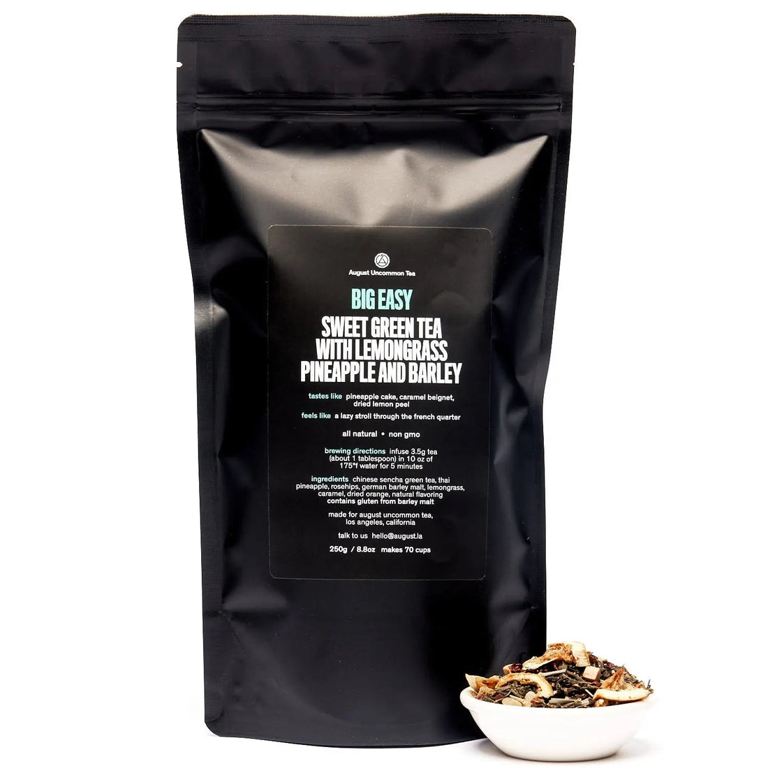 Big Easy Pineapple Caramel Green Tea in a 70-cup bag from August Uncommon Tea, showcasing the tea packaging with fresh tea leaves.