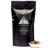 Big Easy Pineapple Caramel Green Tea in a 70-cup bag from August Uncommon Tea, showcasing the tea packaging with fresh tea leaves.