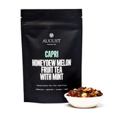Herbal tea bag of August Uncommon Tea Capri Honeydew Melon Mint Tea, caffeine-free, in a 15-cup bag packaging.