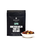 Four cups of August Uncommon Tea Capri Honeydew Melon Mint herbal tea, featuring fresh melon and mint ingredients.
