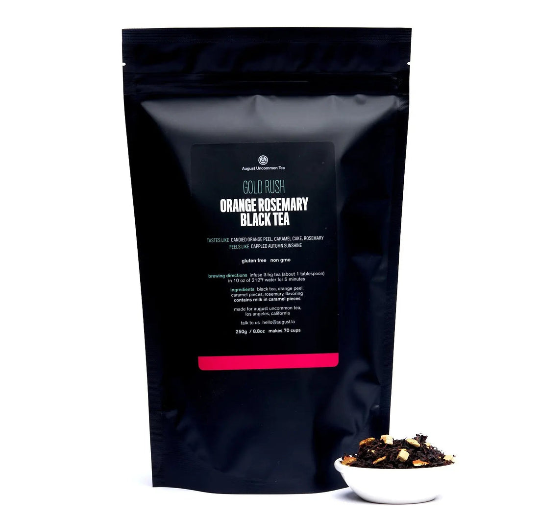 August Uncommon Tea Gold Rush orange rosemary caramel black tea in a 70-cup tea bag, with vibrant orange and caramel notes.