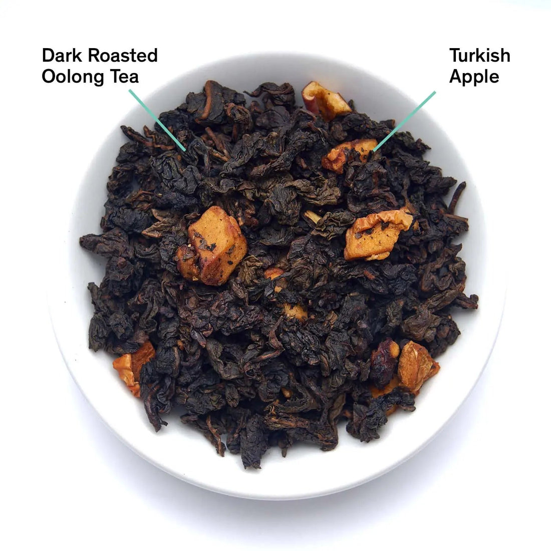 Close-up of burnt apple oolong tea leaves from Avalon by August Uncommon Tea, showing dark rolled oolong leaves with burnt apple aroma.