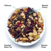 Illustration of Mojave Smoky Hibiscus Cherry Herbal Tea leaves from August Uncommon Tea, showing dried tea leaves and floral elements.