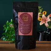 August Uncommon Tea Essentials Black Gold black tea in a 70-cup bag, ready for brewing, with rich dark tea leaves visible.